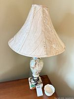 Full view of lamp with shade on wooden surface