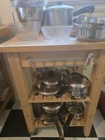 Full view of cart with cookware, bowls and strainer