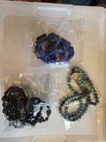 Three necklaces in separate plastic bags