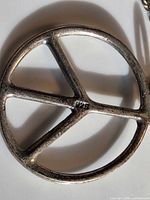 Close-up of peace sign pendant showing 925 hallmark