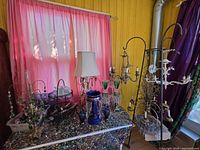 Overall lot on splatter table showing lamp, glass pieces, chandelier frames