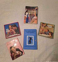 All five books arranged showing front covers