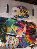 Overall lot showing fabric pieces, ribbon colours and plastic bin