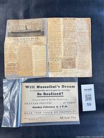 Overall lot showing flyer in sleeve and folded page with clippings