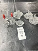 All seven clear cut glass pieces grouped together