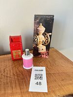 All three Avon novelty items: mailbox coin bank, spool with thimble, boxed coffee grinder bottle