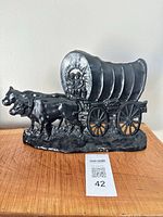 Front view showing wagon, oxen and driver detail