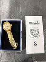 Watch in presentation box showing dial, bracelet and case