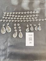 All four bead strands and eight teardrop prisms laid out on surface