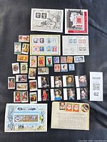 Full lot overview showing all stamps and sheets on black background