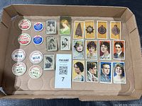 Top view showing all cigarette cards and milk caps arranged in box