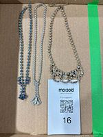 Front view showing all three rhinestone necklaces inside box