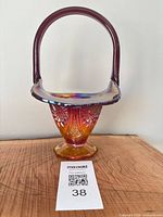 Front view showing full basket with handle and pressed pattern