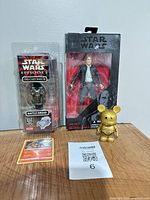 Group shot of all four items showing packaging and loose figure