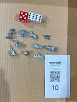 Group view of all ten metal tokens and three dice