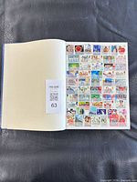 Open album showing partially filled page of British commemorative stamps