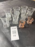 All seven juice glasses and two pink mugs grouped