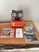 Viewer on top of box with three reel packets laid out