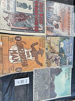 Group shot of all five sheet music pieces on surface