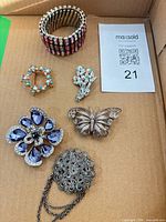 Entire lot showing bracelet, five brooches and pendant
