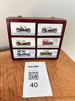 Front view of display case with drawers labelled by boxed cars