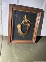 Framed brass gorget with crest inside wood shadow box