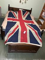Full view of Union Jack flag spread on bed