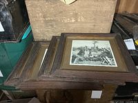 Stack of four square oak-framed photos