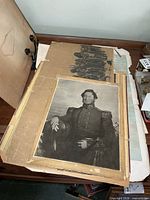 Stack of unframed prints showing top portrait and others