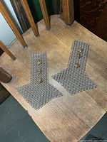 Pair of chain shoulder epaulettes on chair