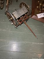 Overall view of wood and metal limber wagon on floor