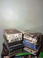 Two stacks of war-themed DVDs showing case spines and titles