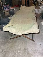 Top angled view of entire cot showing canvas surface and frame
