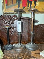 All three wooden hat stands on table