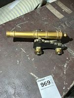 Side view of brass cannon on cast iron carriage