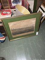 Framed Verdun print leaning against chest