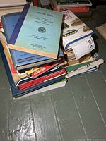 Stack of assorted military books, top book 'Use of Tools'