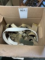 Box containing multiple canvas belts and straps