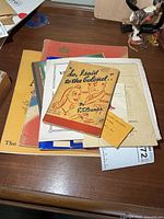 Stack of various vintage military booklets and small cards