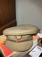 Front view showing CANADA embroidery, cloth crown badge, leather chin strap