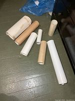 Seven rolled posters and tubes on floor