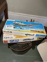 Stacked view of both model kit boxes showing titles and scale