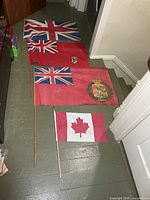 All four flags laid out showing designs and poles