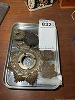 Tray with all six brass Canadian military badges