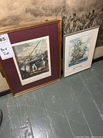 Both framed prints standing on floor