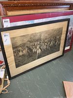 Full view of framed print leaning against wall