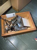 Wooden tray holding multiple metal shoe trees