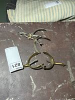 Two brass-tone spurs and two silver-tone spurs on tabletop
