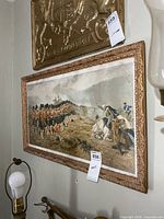 Framed battle scene print on wall showing full view