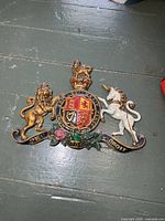 Full view of cast iron painted coat of arms plaque